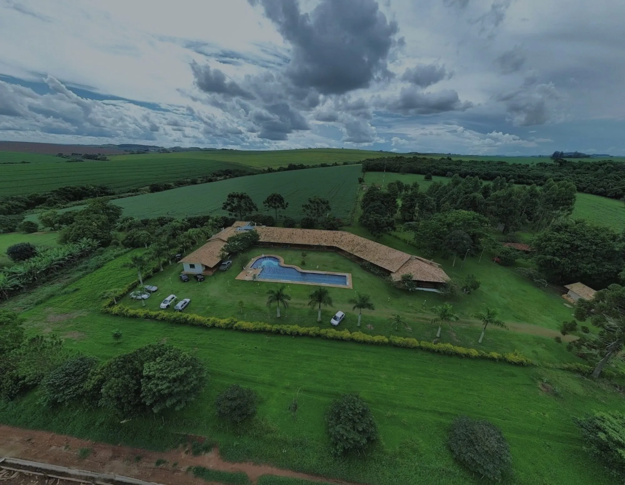 Aerial view of a ranch house, before editing