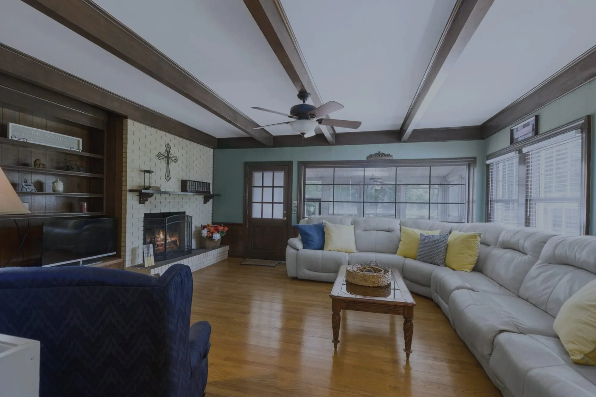 Living room with a beamed ceiling, before editing