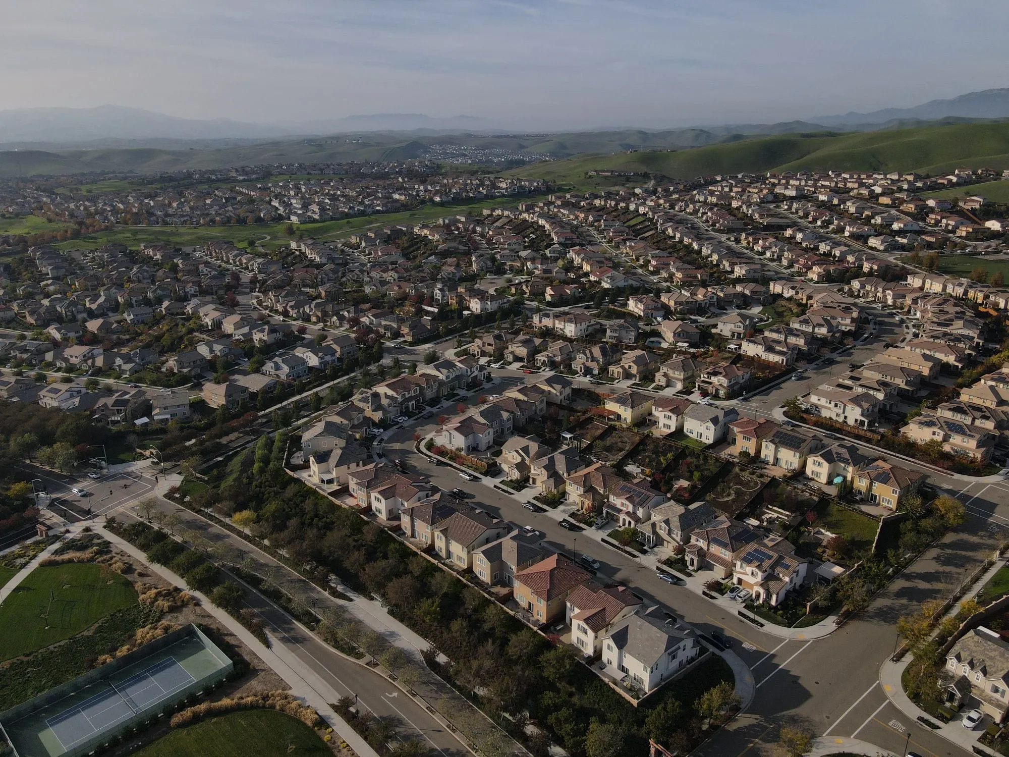 Aerial view of a hillside subdivision at golden hour