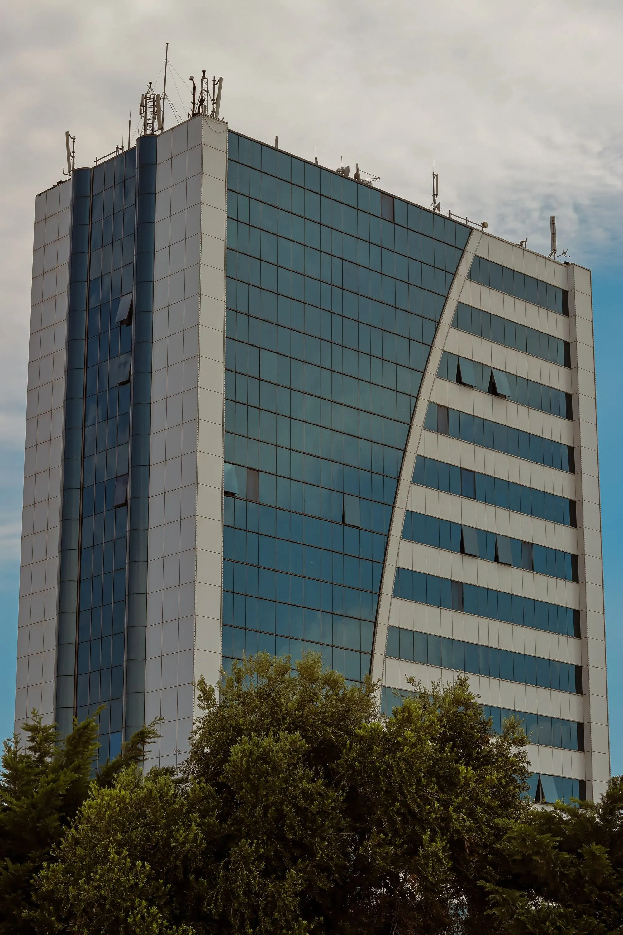 Glass and stone office tower against a blue sky