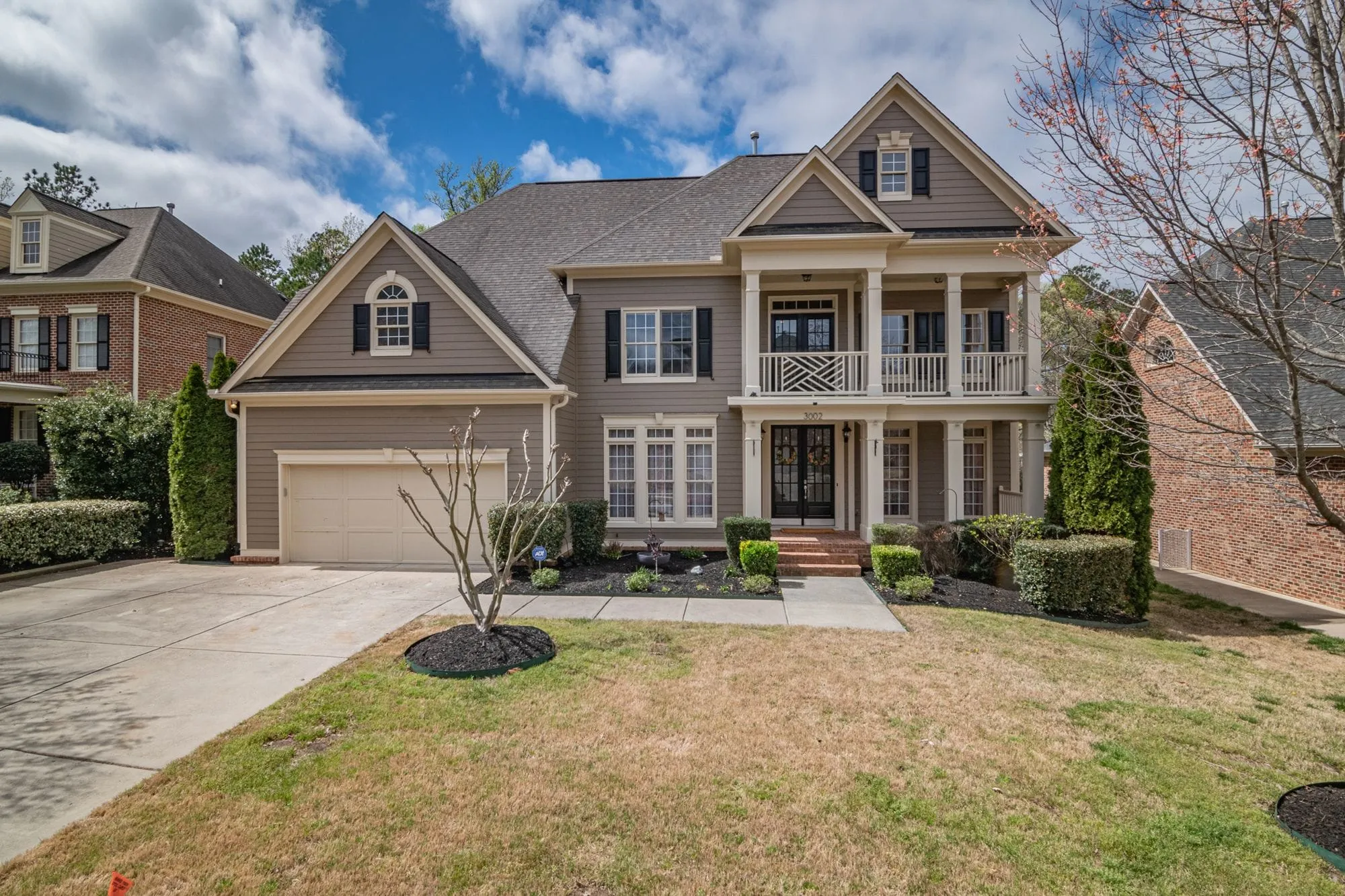 Two-story house with a stone path and a front lawn