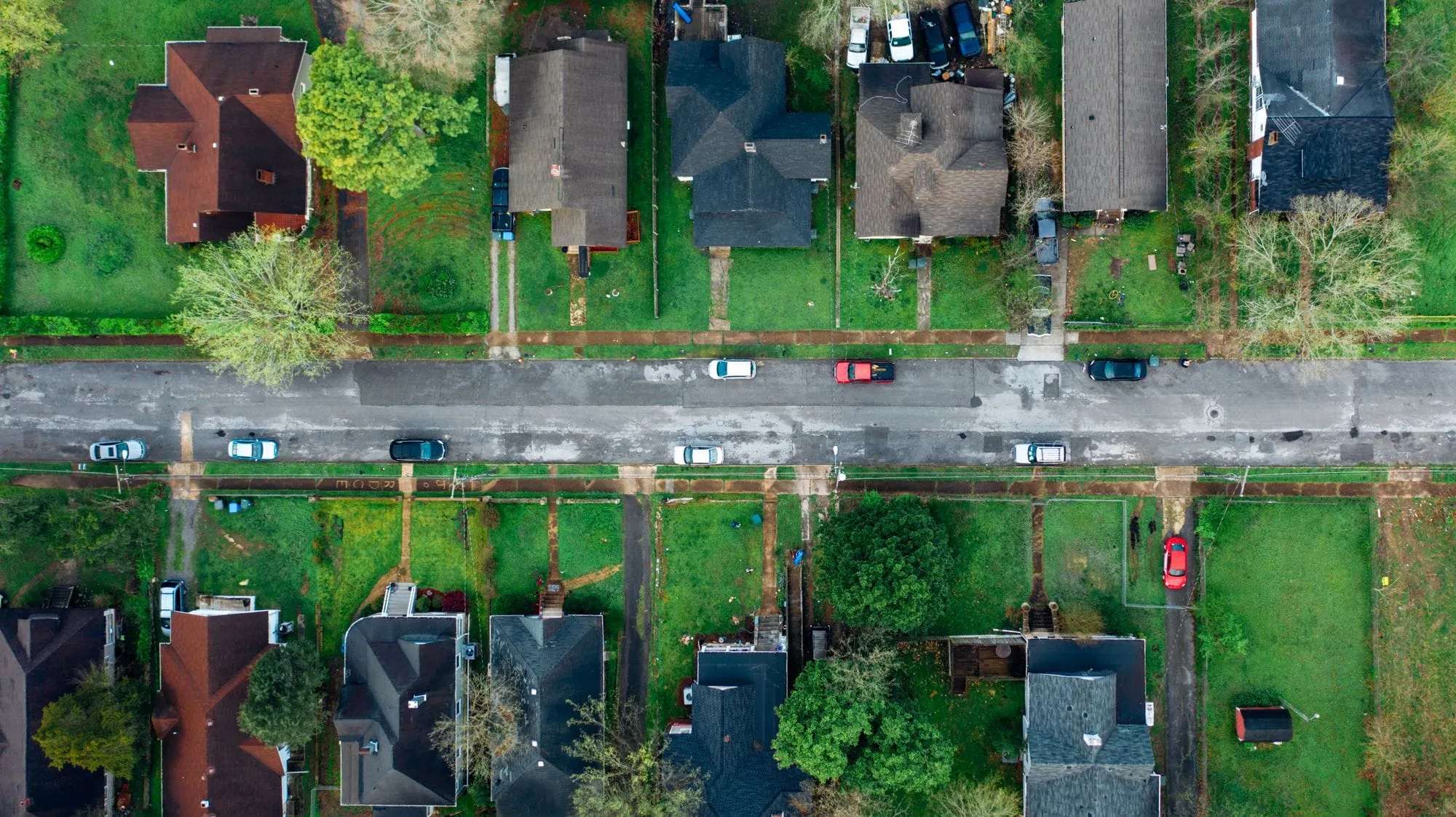 Aerial view of a street of houses with green lawns